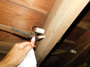 Knob and Tube wiring being tested with a voltage detector in Matawan NJ